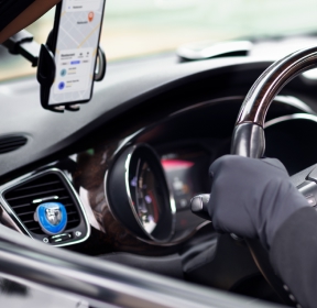 A hand on a steering wheel.